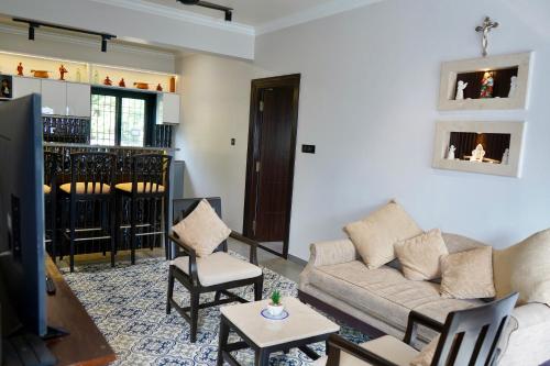 a living room with a couch and a table at SeaBreezeMajorda in Majorda