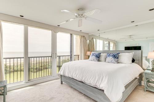 a bedroom with a bed and large windows at Oceanfront Atlantic Beach Condo with View! in Atlantic Beach