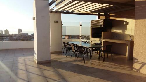 een patio met een tafel en stoelen op een balkon bij Apartamento En Viña Del Mar in Viña del Mar