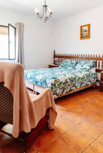 a bedroom with a bed with a blanket on it at Casa Froscar in Bermejo