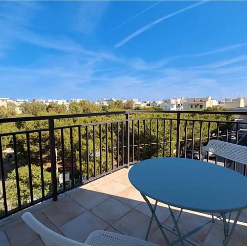 a patio with a table and chairs on a balcony at Ricomincio da Polignano in Polignano a Mare