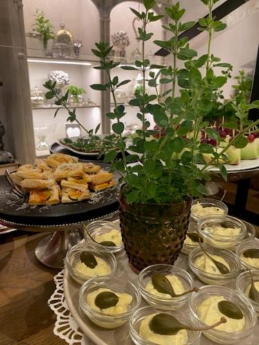 a table with plates of food and a potted plant at Gästehaus Weiherhof in Alpbach