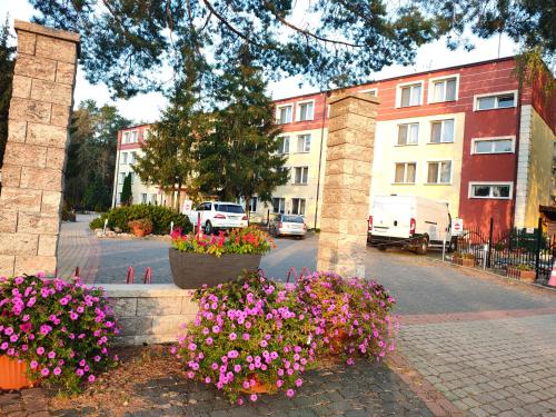 a group of flowers in front of a building at SELMENT RESORT Mazury in Ełk