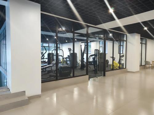 a gym with a row of treadmills and machines at Soft Life Crib in Lavington - Dine, Wine & Relax in Nairobi