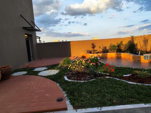 a garden in front of a building with flowers at Soft Life Crib in Lavington - Dine, Wine & Relax in Nairobi