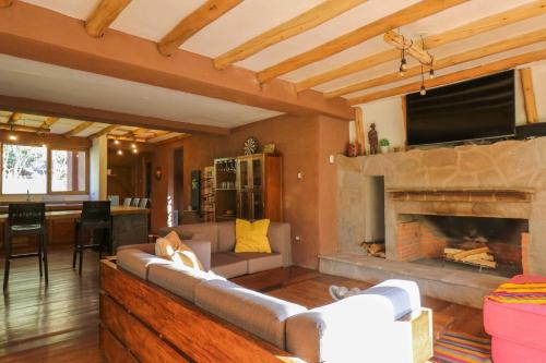 a living room with a couch and a fireplace at Divine 3BR House in Valle Sagrado in Calca