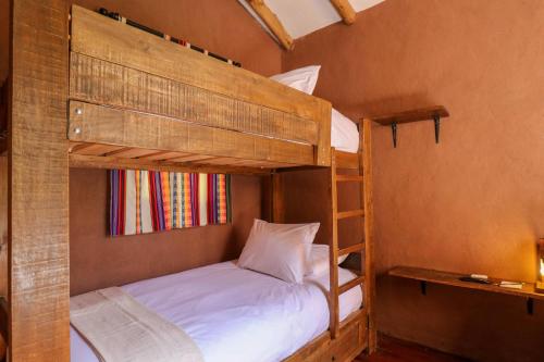a bedroom with two bunk beds in a room at Divine 3BR House in Valle Sagrado in Calca