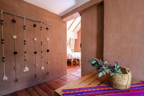 a room with a table and a vase of flowers at Divine 3BR House in Valle Sagrado in Calca