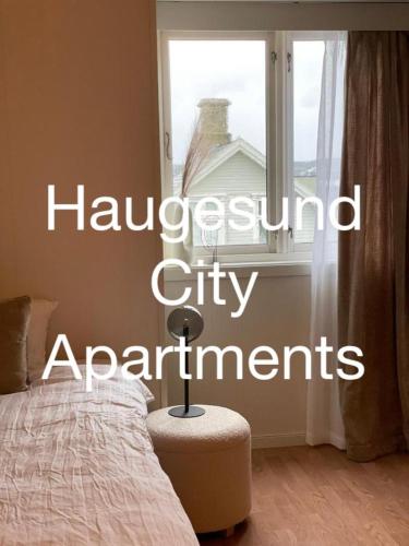 a bedroom with a bed and a window with the wordsanguard city apartments at Haugesund City Apartments in Haugesund