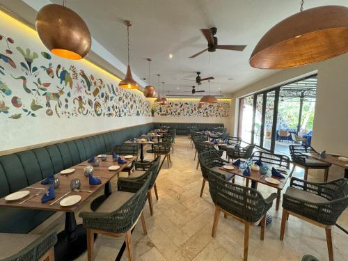 a dining room with wooden tables and chairs at Fiesta Americana Puerto Vallarta All Inclusive & Spa in Puerto Vallarta