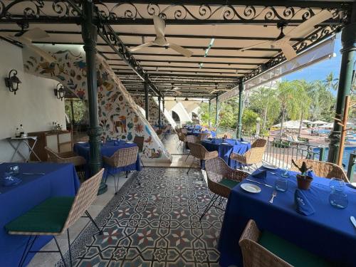 a dining room with blue tables and chairs at Fiesta Americana Puerto Vallarta All Inclusive & Spa in Puerto Vallarta