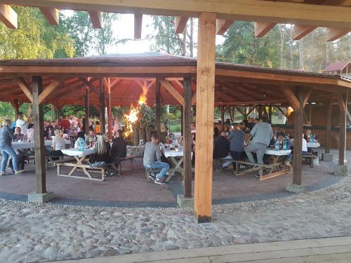 a group of people sitting at tables in a pavilion at SELMENT RESORT Mazury in Ełk