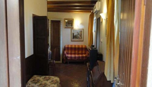 a hallway with a couch and a chair in a room at La Terrazza di Spello in Spello