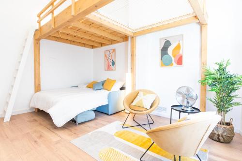 a bedroom with a bed and a chair at Le haut perché in Colmar