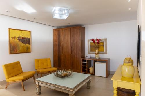 a living room with two chairs and a table at Costa do Sol Boutique Hotel in Búzios