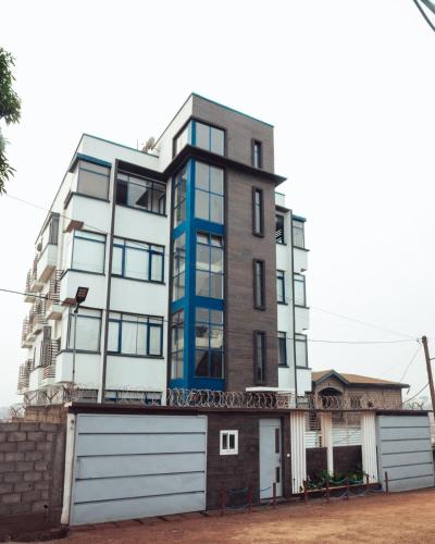 an apartment building with a garage at La RESIDENCE LES HIBISCUS in Djoungolo