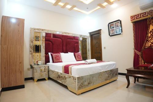 a bedroom with a large bed in a room at Metro One Hotel in Lahore