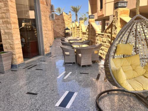 a patio with chairs and a swing on a building at Reef House in Marsa Alam City