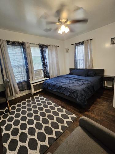 a bedroom with a bed and a ceiling fan at TKC Homes in Irvington
