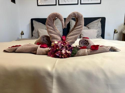 two stuffed animals in towels on a bed at Apartmán Ranč in Martin