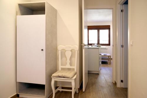 a room with a closet with a chair and a mirror at vallespin 43 parking, wifi in Avila