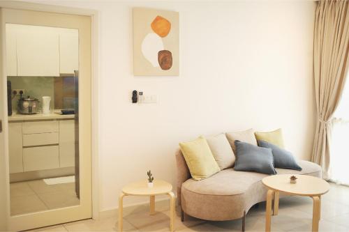 a living room with a couch and two tables at Afiniti 2BR Scandinavian Escape - Legoland 300m in Iskandar Puteri