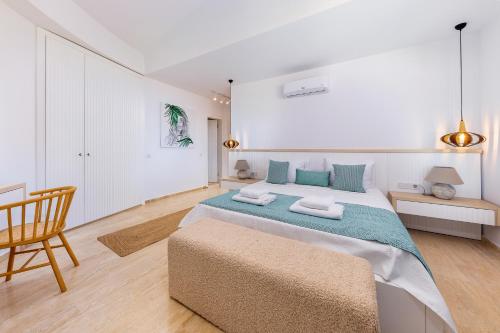 a bedroom with a large bed and a chair at Villa Casa Che in Kalkan