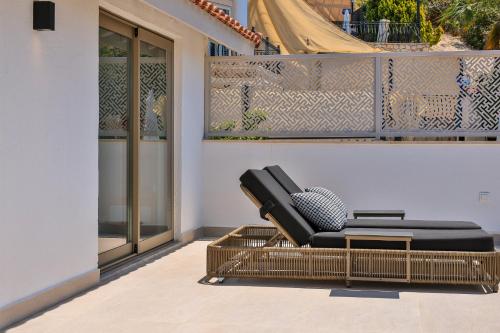 a black chair sitting on a balcony at Villa Casa Che in Kalkan