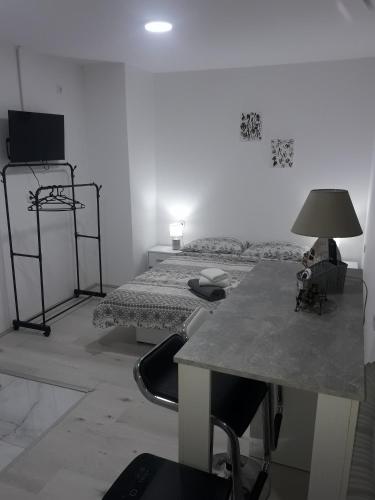 a room with two beds and a table with a lamp at VilaNatalija APARTMANI in Apatin