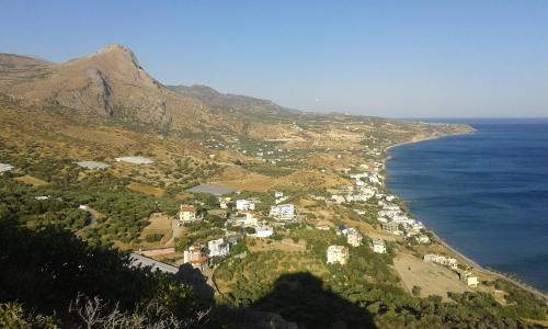 an aerial view of a town on a hill next to the ocean at Jason Rooms & Studios in Keratokampos