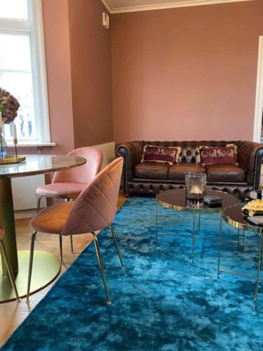 a living room with a couch and tables at Strandvillan Gnesta in Gnesta