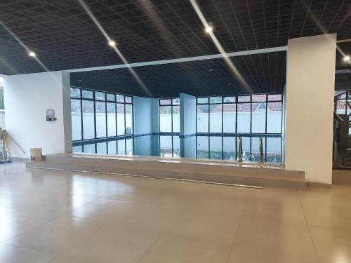 a large empty room with windows and a dance floor at Soft Life Crib in Lavington - Dine, Wine & Relax in Nairobi