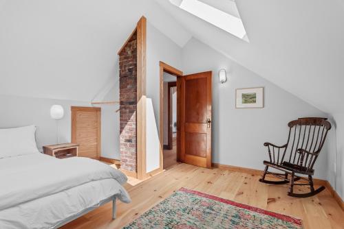 a bedroom with a bed and a chair in a room at Chambers Hollow in Walton