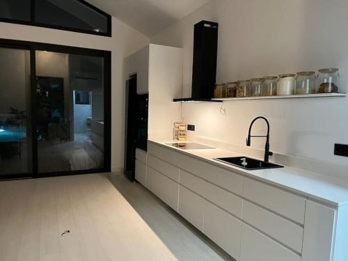 a kitchen with a sink and a counter top at PoolHouse in the Historic Center in Baena