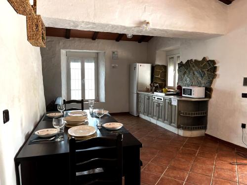 una cucina con tavolo, piatti e bicchieri da vino di Hacienda de la Cruz ad Ayamonte