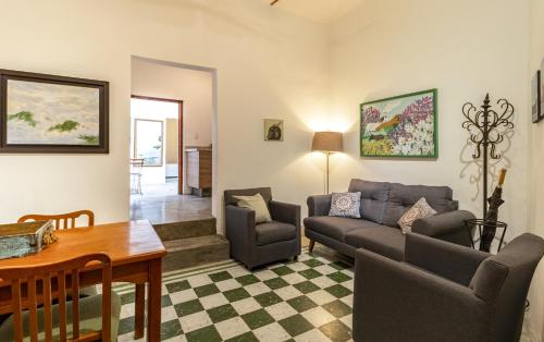 a living room with a couch and chairs and a table at Suite en Centro Historico Terraza, Wifi, Desk, AC in Querétaro