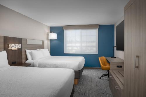 a hotel room with two beds and a television at Holiday Inn Express Spokane Airport by IHG in Spokane