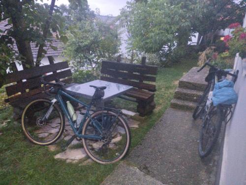 two bikes parked next to a table and a bench at Nature in Gacko