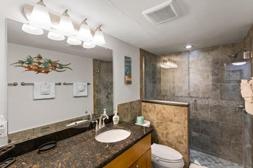 a bathroom with a sink and a toilet and a shower at Fifty Gulfside Condominiums in Clearwater Beach