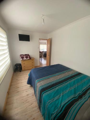 a bedroom with a bed and a television in it at Arriendos Parra's in Coquimbo