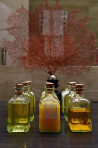 a group of four bottles of oil on a table at Seven Historical Suites in Trieste