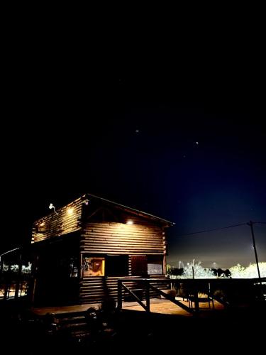a wooden cabin with lights on it at night at Cabaña Vista del Plata in Las Compuertas