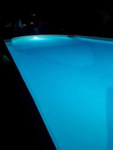 a pool with blue lights in the dark at Agriturismo Tognoloni in Gubbio