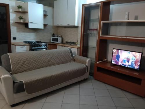 a living room with a couch and a tv in a kitchen at Il Nido in Rozzano