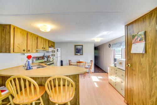 a kitchen with wooden cabinets and a table and chairs at Yale Home in the Heart of Pheasant Hunting Country in Yale