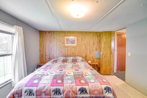 a bedroom with a bed with a colorful quilt at Yale Home in the Heart of Pheasant Hunting Country in Yale