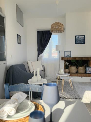 a living room with a couch and a table at Carpe Diem Lesvos in Kerámion