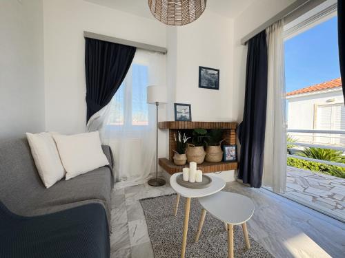 a living room with a couch and a table at Carpe Diem Lesvos in Kerámion