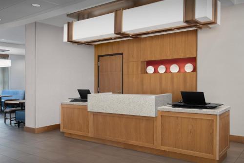 an office lobby with two laptops on a counter at Hyatt Place Boulder Pearl Street - Newly Renovated in Boulder