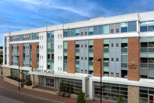 a large white building with a heart place sign on it at Hyatt Place Boulder Pearl Street - Newly Renovated in Boulder
